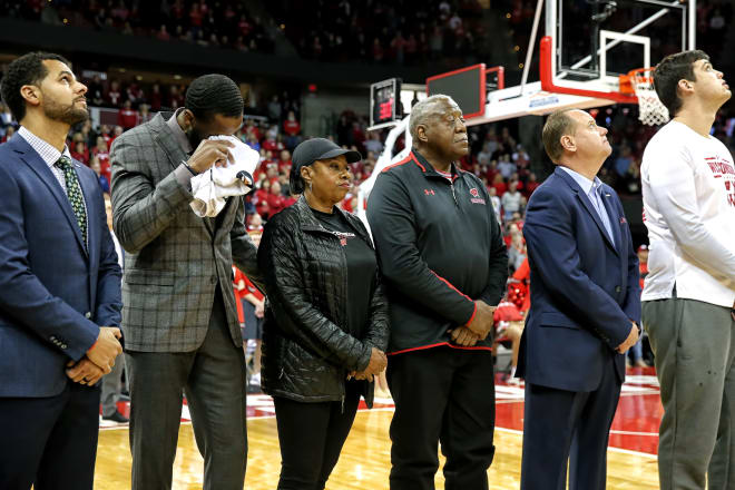 Wisconsin assistants Dean Oliver and Alando Tucker (far left and left) with Howard Moore's parents (center) before Wisconsin's game vs. Eastern Illinois