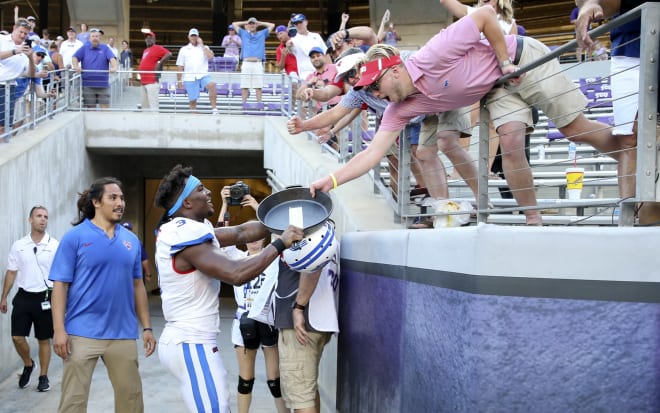 James Proche celebrates with SMU fans after the Mustangs won the Iron Skillet over TCU.