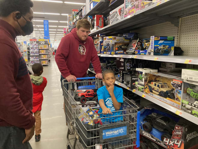FSU football players helped friends from the Boys & Girls Club pick out toys for the holidays on Monday.