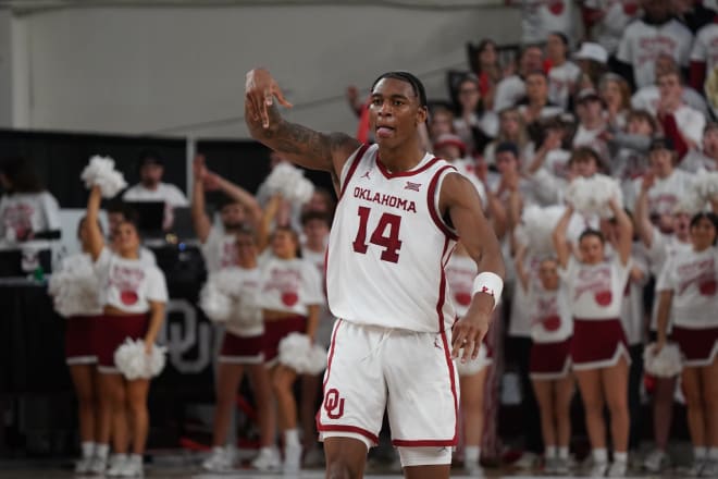 Jalon Moore (14) celebrates after drilling a three-pointer in Oklahoma's game against Arkansas Pine-Bluff