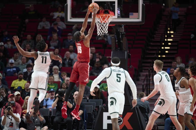 Alabama Crimson Tide forward Noah Clowney (15) dunks the basketball during the first half against Michigan State Spartans guard A.J. Hoggard (11) at Moda Center. Photo | Troy Wayrynen-USA TODAY Sports