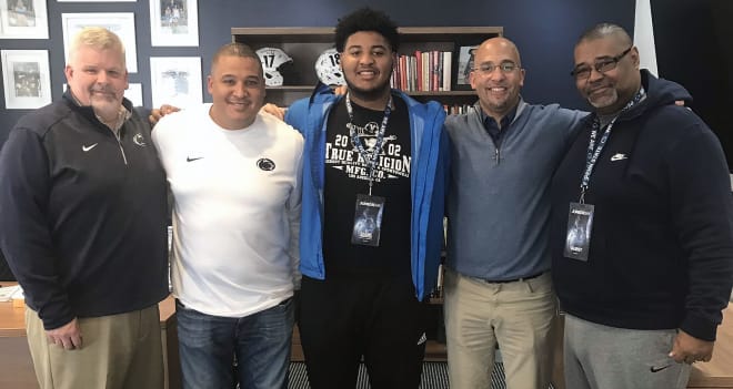 Adams and his father pose with Matt Limegrover, Ja'Juan Seider and James Franklin during his visit in February.