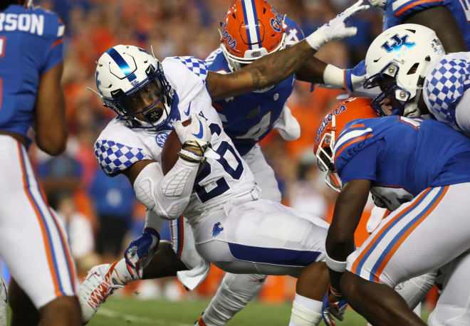Kentucky's Benny Snell fought to break a tackle by the Florida defense.