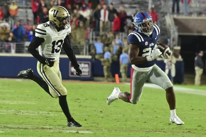 Ole Miss Rebels running back Snoop Conner (24) runs the ball while defended by Vanderbilt Commodores cornerback Gabe Jeudy-Lally (13) during the fourth quarter at Vaught-Hemingway Stadium. Mandatory Credit: Matt Bush-USA TODAY Sports