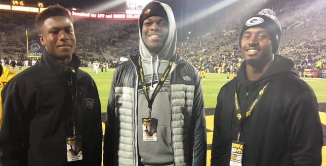Cameron Brown, left, with Ronnie Perkins and Dallas Craddieth at Iowa on Saturday.