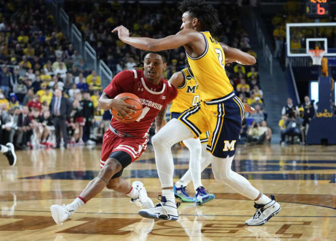 Wisconsin guard Kamari McGee (4) drives on Michigan guard Kobe Bufkin (2)