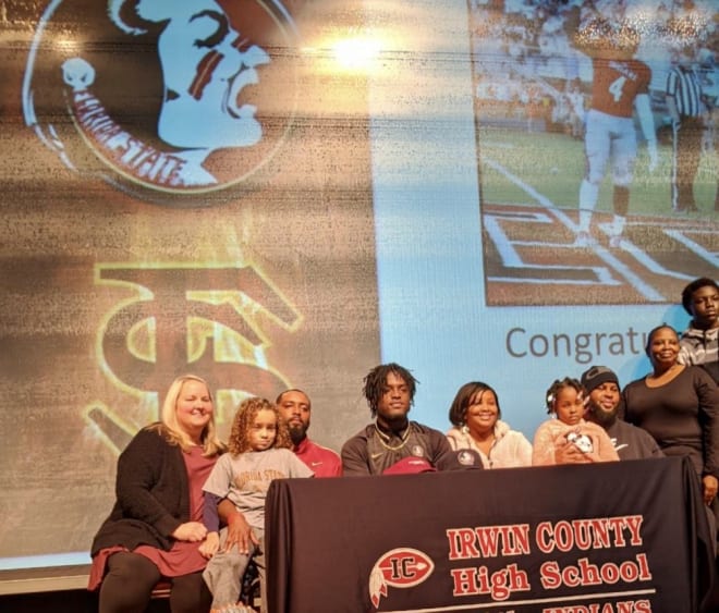 Linebacker DJ Lundy is joined by family and friends at Irwin County High School in Georgia on Wednesday as he signs with the Seminoles.