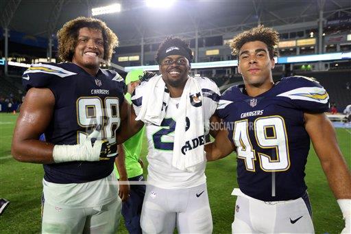 Former Irish defenders Isaac Rochell (left) and James Onwualu survived roster cuts and will remain members of the Los Angeles Chargers for 2017. Former Irish running back C.J. Prosise (middle) enters his second season with the Seattle Seahawks.
