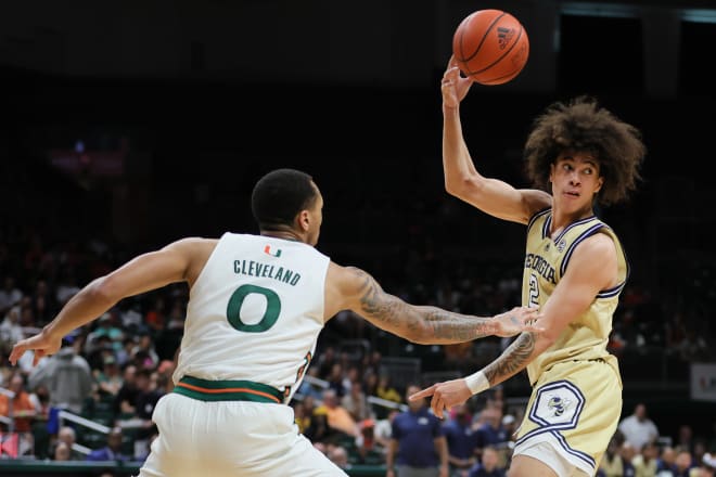 Naithan George dishes the ball around Matthew Cleveland at Miami