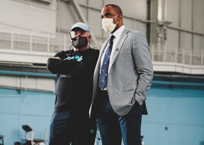 New UNC basketball coach Hubert Davis spoke to the Tar Heels' football team after practice Tuesday morning.