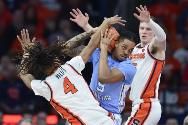 Syracuse defenders swarming Armando Bacot (AP Photo/Adrian Kraus)