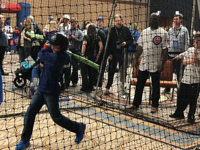 Carson gets hitting tips from former Major League outfielder Brian McRae Saturday. 