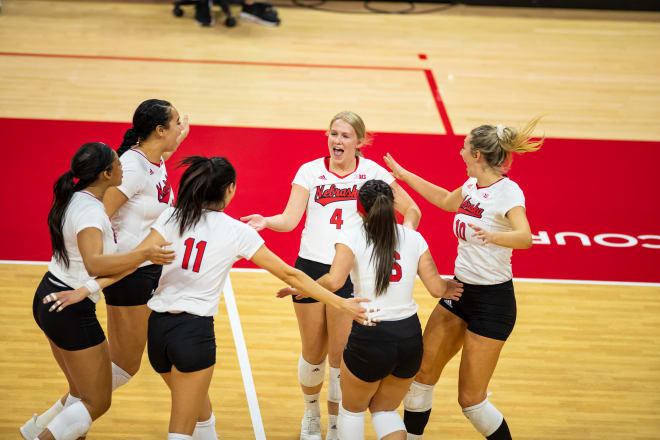 Nebraska setter Anni Evans celebrates with her teammates