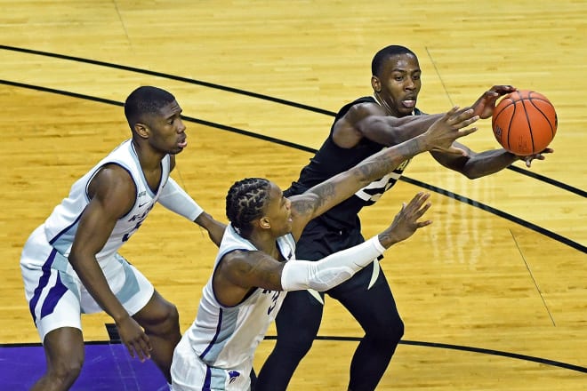 McKinley Wright IV battles for a loose ball