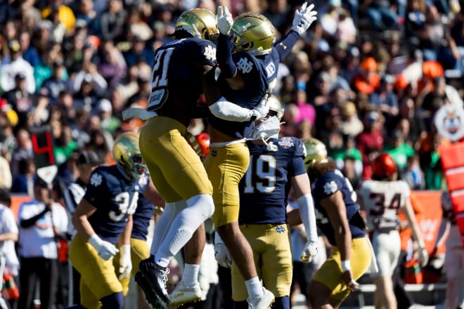 Safety Adon Shuler (21) and cornerback Jaden Mickey (7) celebrate one of many big plays by the Notre Dame defense in a 40-8 Sun Bowl win.