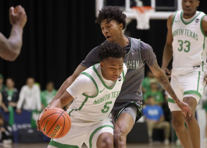 North Texas guard Tylor Perry (5) is fouled by UAB guard Eric Gaines, right, during the first half of a Conference USA men's tournament semifinal