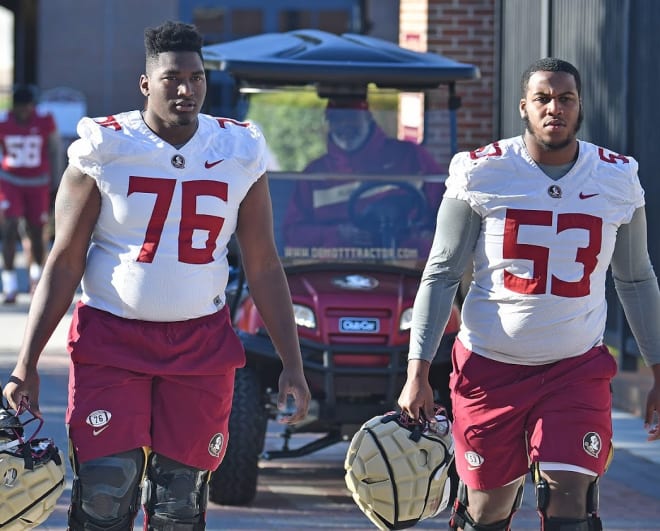 Young linemen Darius Washington (No. 76) and Maurice Smith walk to practice.