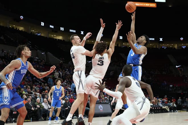 Duke's Jeremy Roach, right, shoots over Xavier's Colby Jones, middle, and Jack Nunge during Friday's game. 