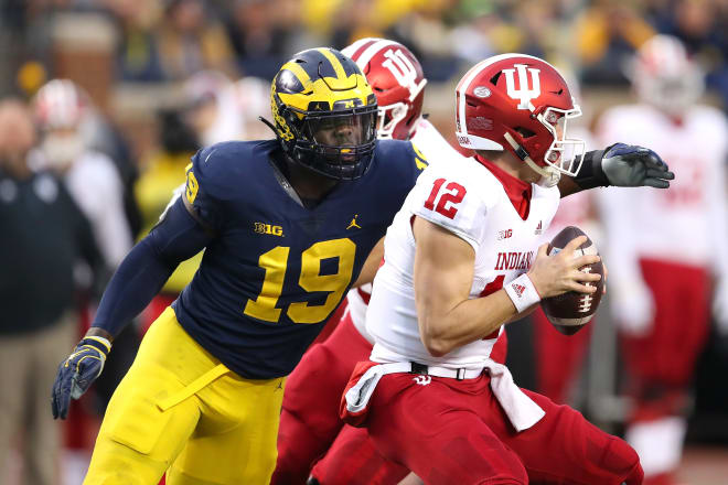 Michigan Wolverines football's Kwity Paye is still working out with the team for the time being.