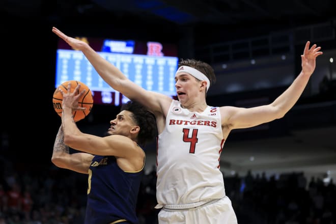 Notre Dame's Prentiss Hubb, left, drives to the basket against Rutgers' Paul Mulcahy during the second overtime of a First Four game in the NCAA men's college basketball tournament Wednesday, March 16, 2022, in Dayton, Ohio. Notre Dame won 89-87 in double overtime.