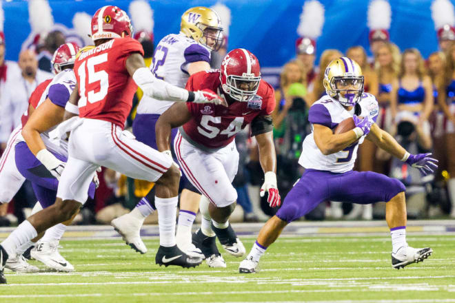 Washington tailback Myles Gaskin (9) carries the ball as Alabama defensive lineman Dalvin Tomlinson (54) and Alabama defensive back Ronnie Harrison (15) defend during the first half of the Peach Bowl on Saturday, Dec. 31, 2016, at the Georgia Dome in Atlanta.
