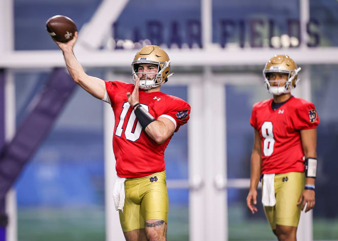 Wake Forest transfer Sam Hartman (10) throws a pass Wednesday in a drill during Notre Dame's first spring football practice as freshman Kenny Minchey (8) looks on. 