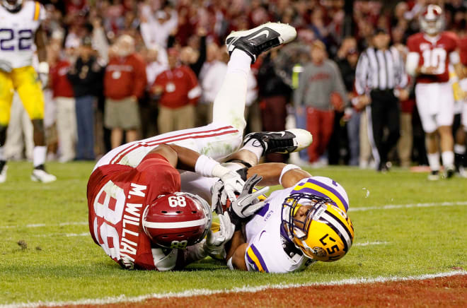 LSU safety Eric Reid, right, tears the ball away from Alabama tight end Michael Williams during a game in 2011. Photo | Getty Images 