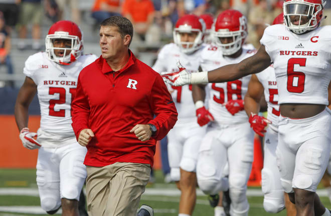 Head coach Chris Ash of the Rutgers Scarlet Knights runs out with the team before the game against the Illinois Fighting Illiniat Memorial Stadium on October 14, 2017 in Champaign, Illinois.