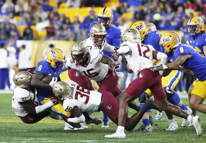 DJ Lundy and Omar Graham wrap up a Pitt run play, one of many by the Panthers that were stuffed.