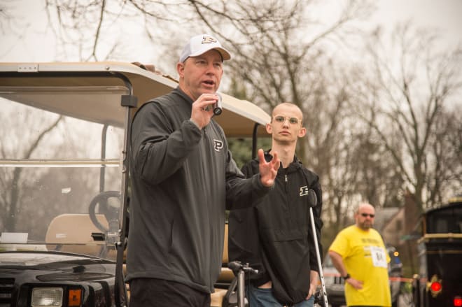 Tyler Trent stand behind coach Jeff Brohm during the 2018 Purdue Challenge 5K. Trent has been an inspiration to many during Trent's battle with the illness. 