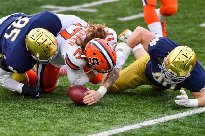 Notre Dame senior defensive tackle Myron Tagovailoa-Amosa (No. 95) forcing a fumble by Syracuse quarterback Rex Culpepper