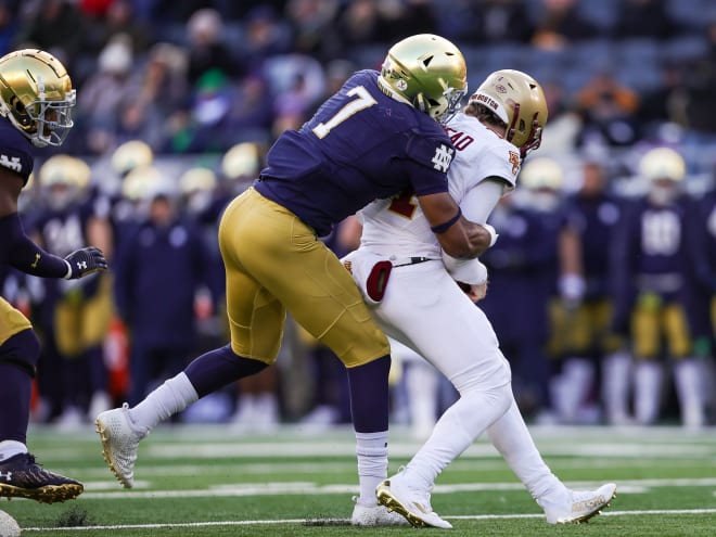 Notre Dame defensive end Isaiah Foskey (7) sacks Boston College quarterback Emmett Morehead (right). 