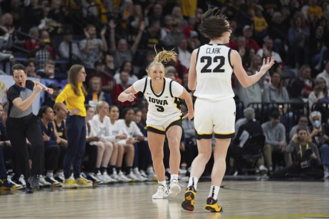 Sydney Affolter (3) celebrates toward Caitlin Clark (22) after making a 3-point basket during the first half against Michigan in the semifinals of the Big Ten women's tournament.