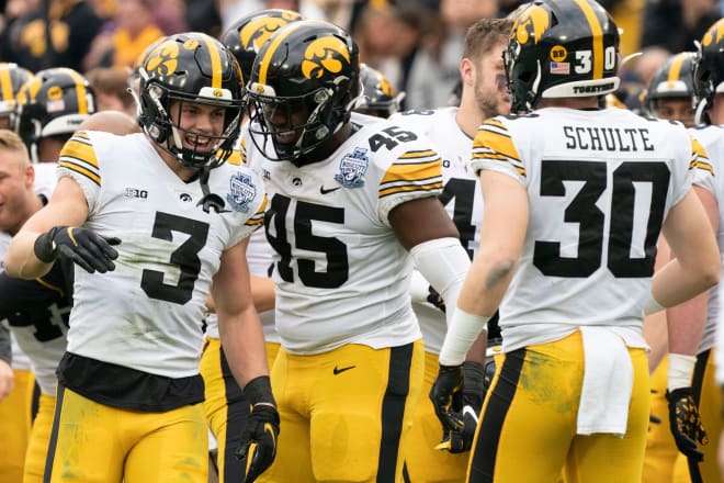 Cooper DeJean, Deontae Craig, and Quinn Schulte celebrate a play during the 2022 Music City Bowl.