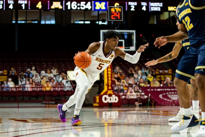 Marcus Carr drives on Michigan 