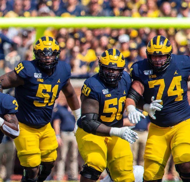 Michigan Wolverines football's Cesar Ruiz (left), Mike Onwenu (middle) and Ben Bredeson