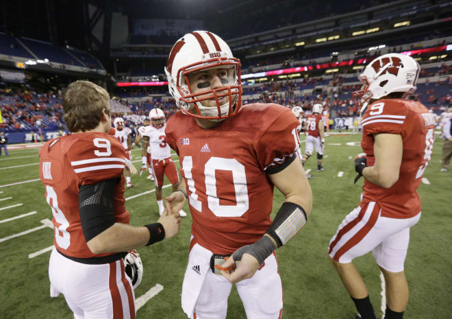 Wisconsin quarterback Curt Phillips (10) is congratulated by Chase Knox, left, after Wisconsin defeated Nebraska 70-31 to win the Big Ten championship NCAA college football game Saturday, Dec. 1, 2012, in Indianapolis.