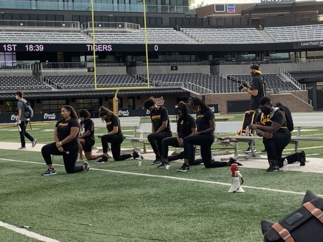 The cabinet members of the Black Student-Athlete Association, who organized Wednesday's march through campus, lead participants in five minutes of silence.