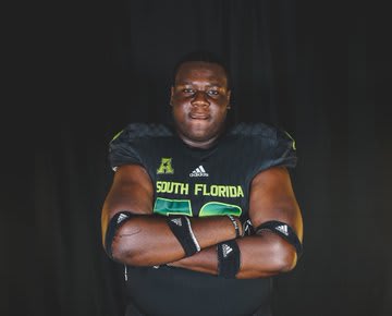 Love poses during his visit to USF