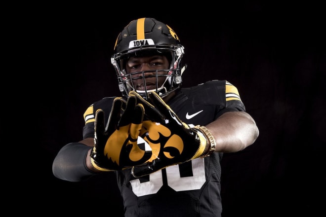 Future Hawkeye Henry Geil tries on an Iowa uniform on his official visit.
