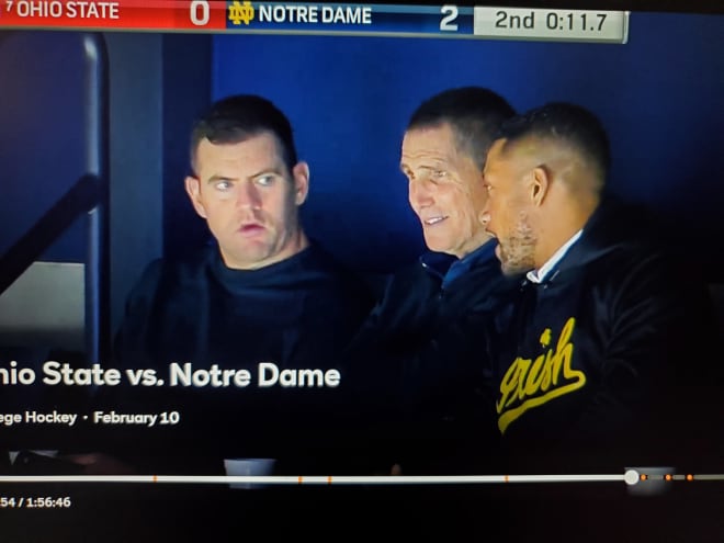 From left to right: Notre Dame tight ends coach Gerad Parker, Utah offensive coordinator Andy Ludwig and Notre Dame head coach Marcus Freeman attend the Irish hockey game Saturday night.