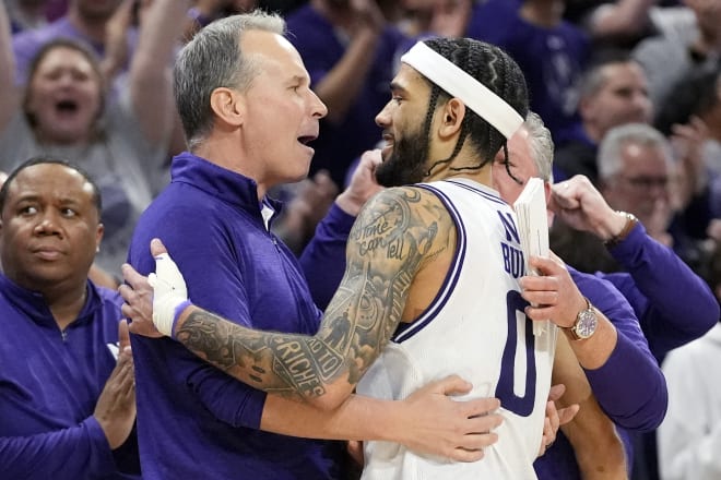Boo Buie and Chris Collins embrace each other after Buie came off the floor for the last time.