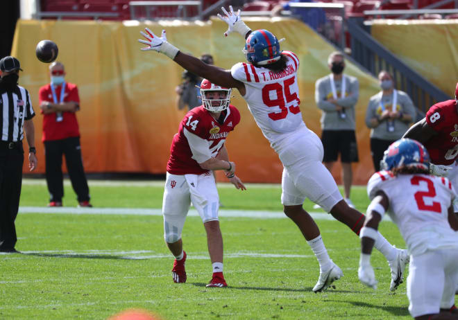 Indiana Hoosiers quarterback Jack Tuttle (14) throws the ball as Mississippi Rebels linebacker Tavius Robinson (95) defends during the first half at Raymond James Stadium. Mandatory Credit: Kim Klement-USA TODAY Sports