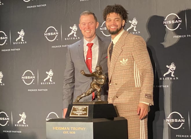 USC coach Lincoln Riley and quarterback Caleb Williams pose with the Heisman Trophy on Saturday night after Williams' win.