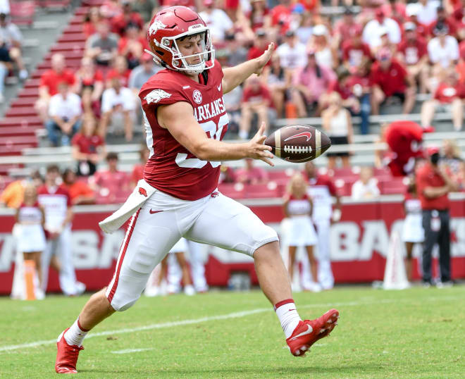 Reid Bauer punts the ball during Arkansas' 2021 game against Rice.