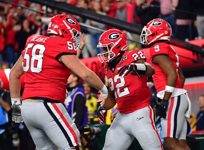 New Tar Heel Austin Blaske (58) celebrates a touchdown at Georgia in the 2023 national championship