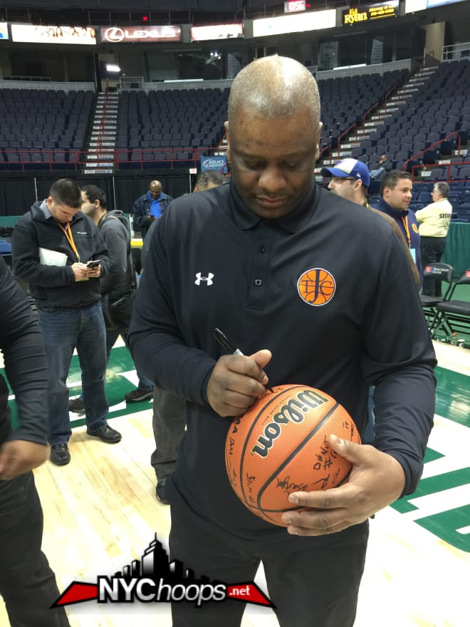 Coach Lawrence "Bud" Pollard signs the game ball