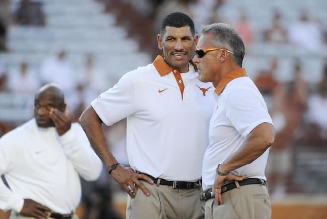 Texas Longhorns wide receivers coach Jay Norvell (left) talks with quarterbacks coach Shawn Watson (right) while Watson was still with Texas. This month, he was promoted from Indiana offensive quality control coach to quarterbacks coach.