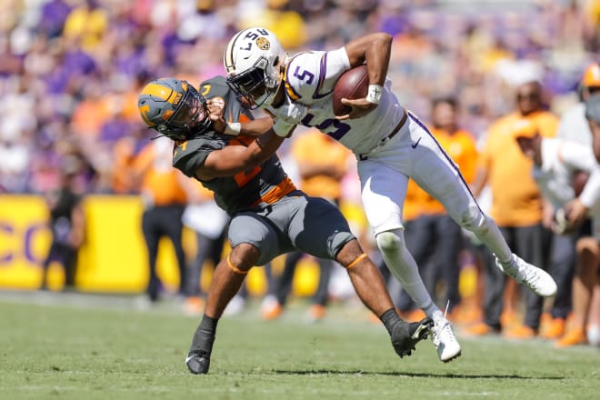 Tennessee linebacker Aaron Beasley (24) tackles LSU quarterback Jayden Daniels (5) during the Vols' win at Tiger Stadium last season.