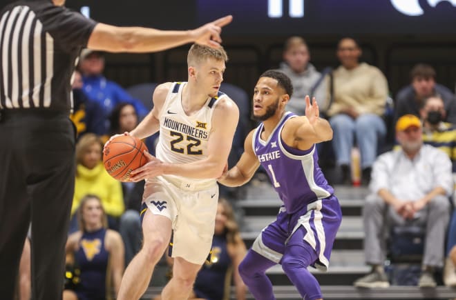 West Virginia Mountaineers guard Sean McNeil (22) looks to pass while defended by Kansas State Wildcats guard Markquis Nowell (1) during the first half at WVU Coliseum.